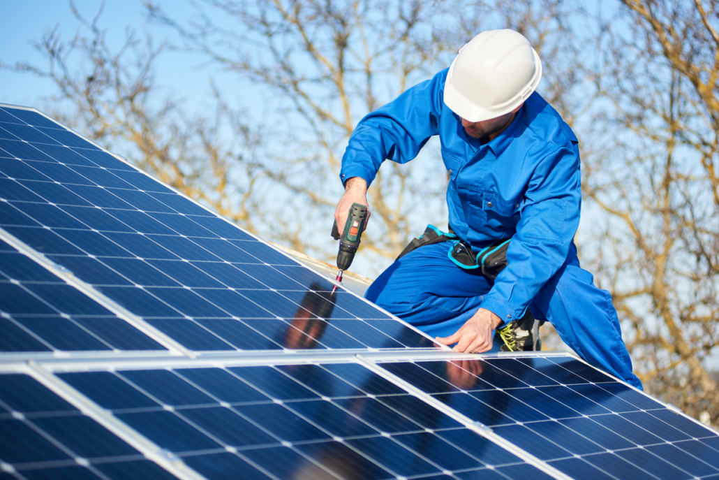 Technician installing new solar panels on a Lake Havasu City home.